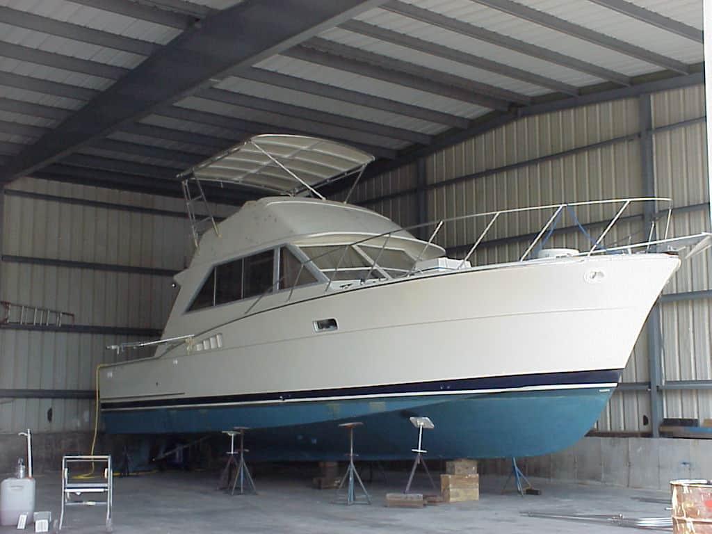 Atlantic Towers Top installed on a Chris Craft Commander FB boat, docked inside a storage facility.